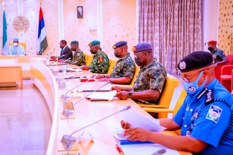 Buhari with service chiefs during the security meeting in Abuja