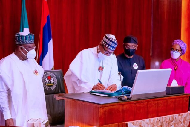 From left: Senate President Ahmad Lawan, President Muhammadu Buhari signing the 2022 Appropriation Bill into law at Aso Rock Presidential Villa on Friday. Right are Speaker of House of Representatives, Femi Gbajabiamila and Finance Minister, Zainab Ahmed