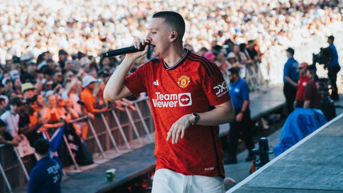 Aitch gave followers a glance on the brand new Manchester United home shirt as he completed at Glastonbury