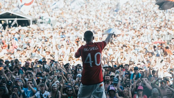 Aitch gave followers a glance on the brand new Manchester United home shirt as he completed at Glastonbury